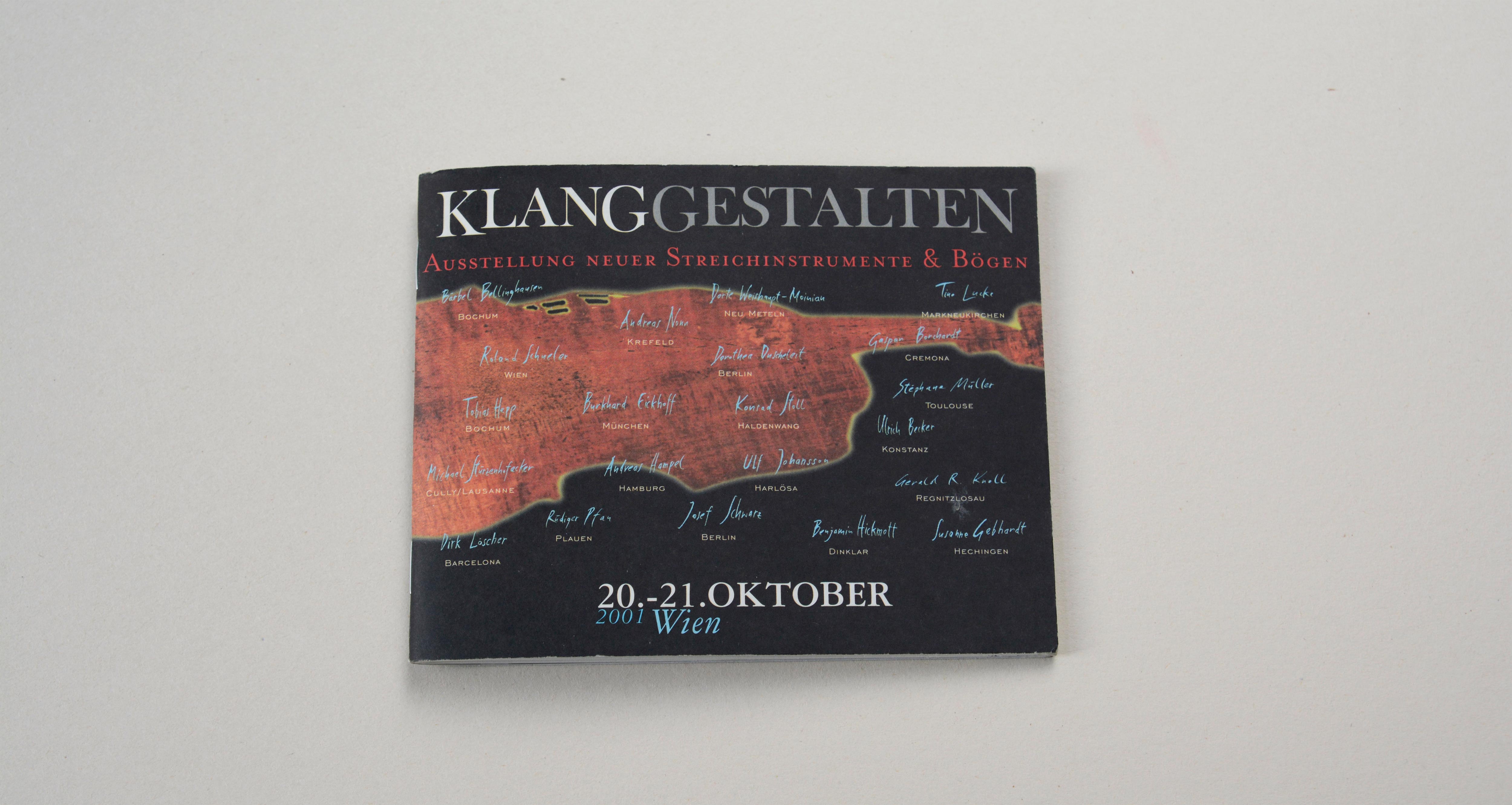 Cover catalogue landscape format. Black background. Large silhouette of violin in the middle. Large logo/title above. Line of text underneath. Several signatures overlayed on entire cover.