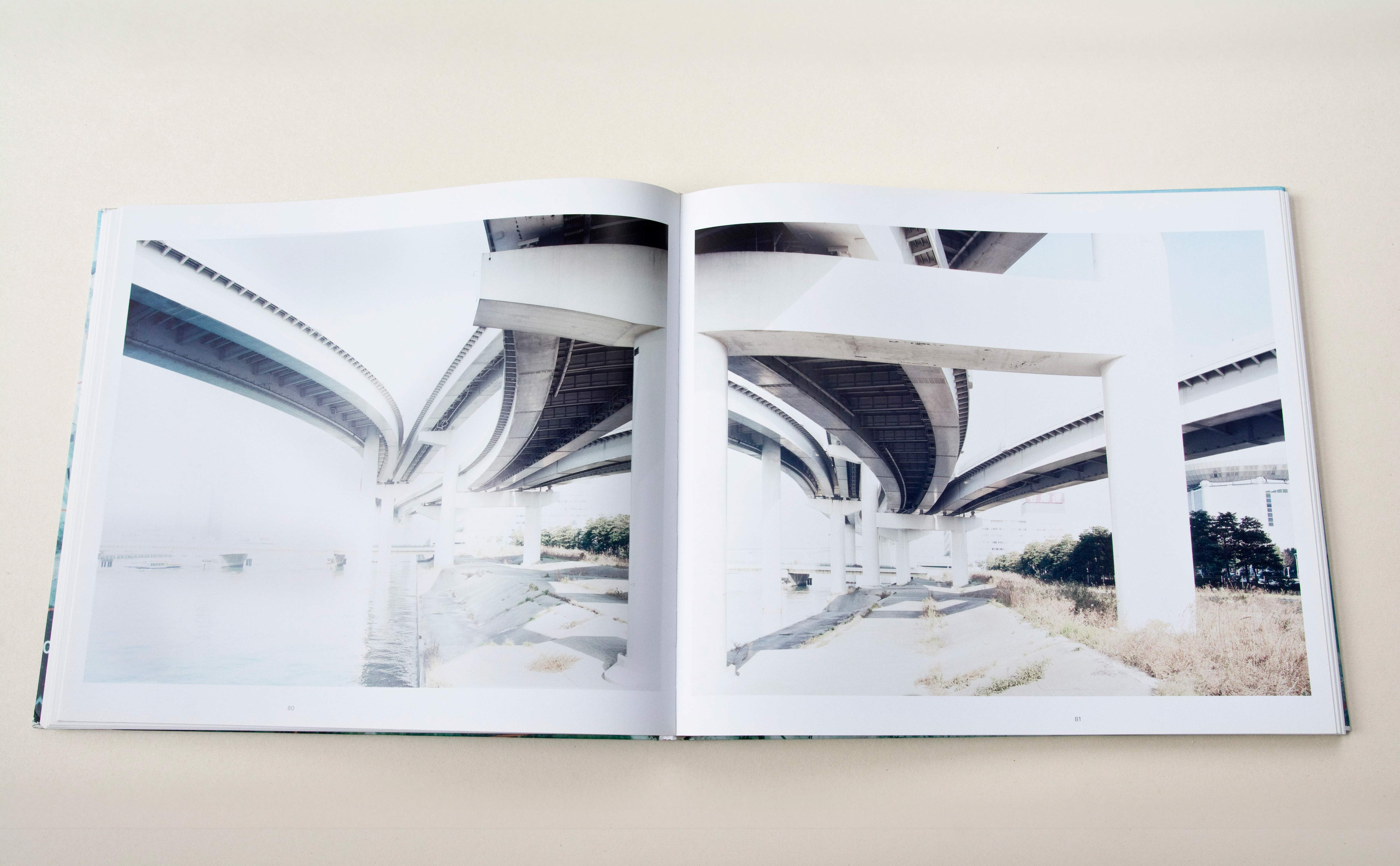 Double page. Large photo with white space around on each page. Left: Under the bridegs of highway junction beside river. Right: Shot from different angle at same location.