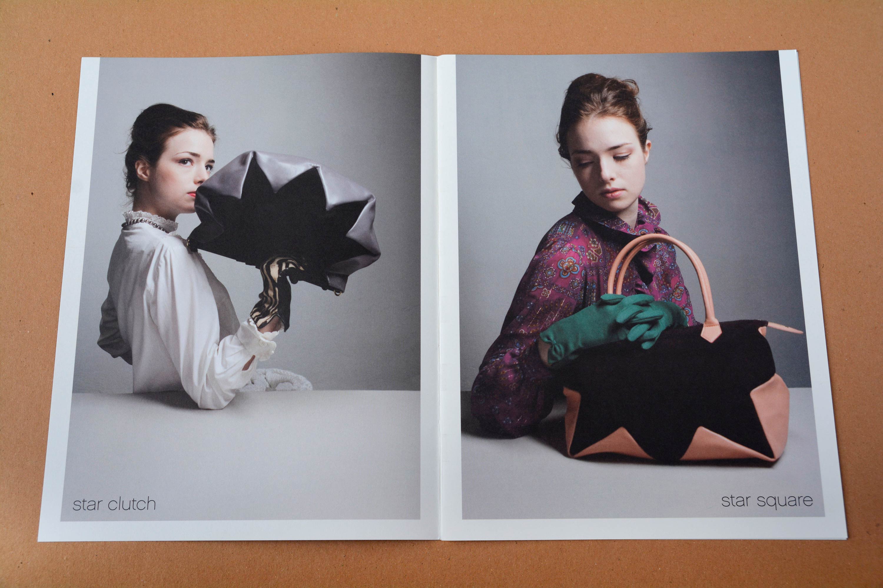 Double page. Full-page photos with partly white space around. Women at a white table holding handbags in front of neutral background. Thin grotesque font overlayed at bottom.