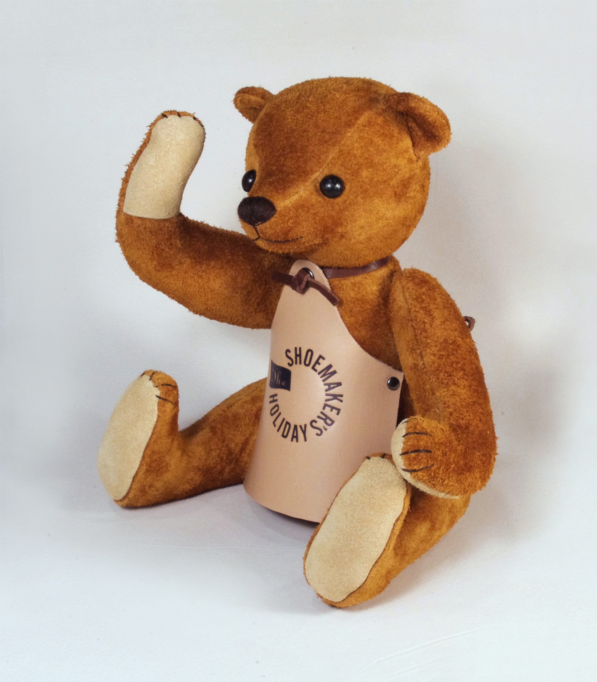 Teddybear wearing leather apron punched with logo.
