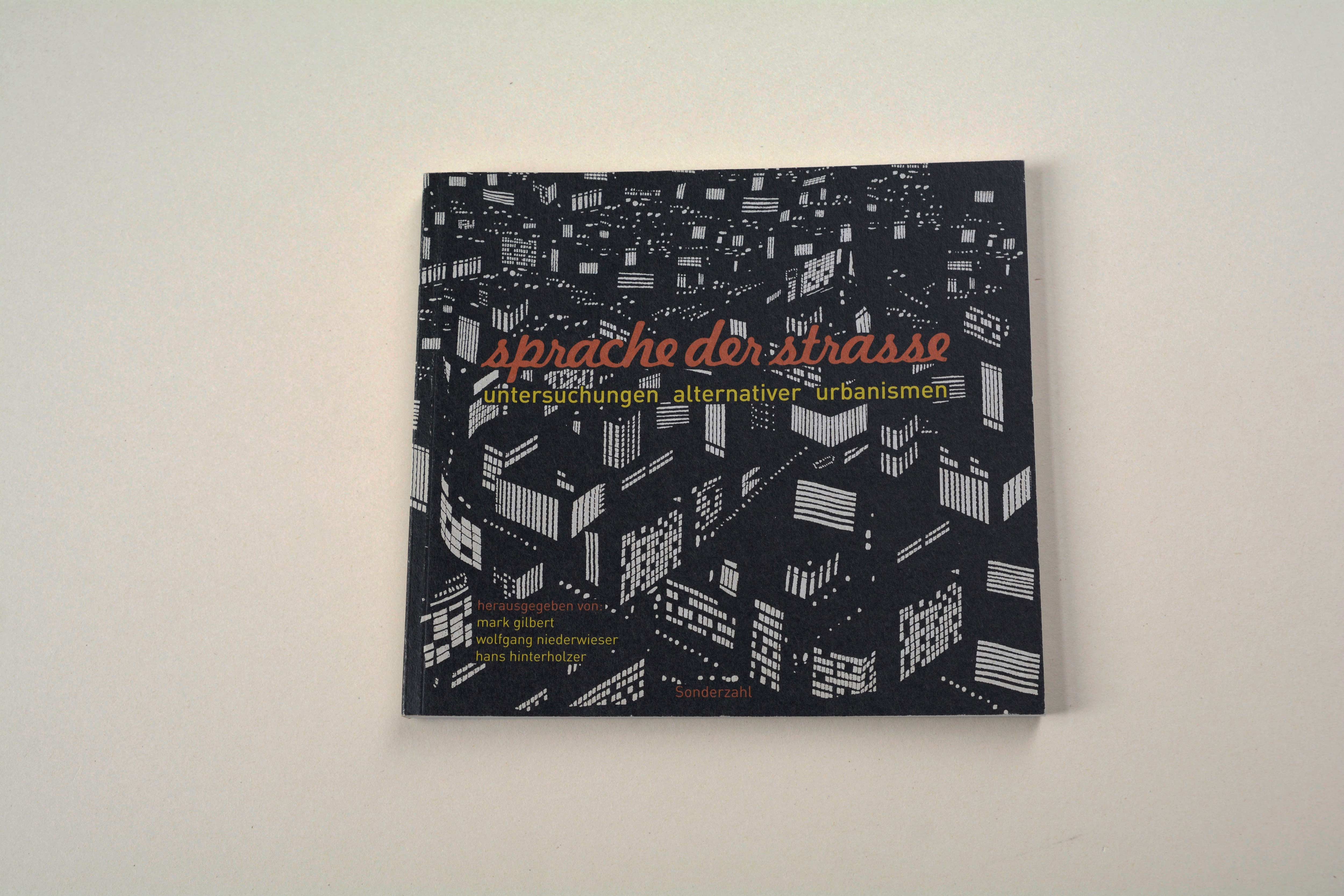 Cover catalogue. B/W illustration of city at night. Title in script font overlayed.