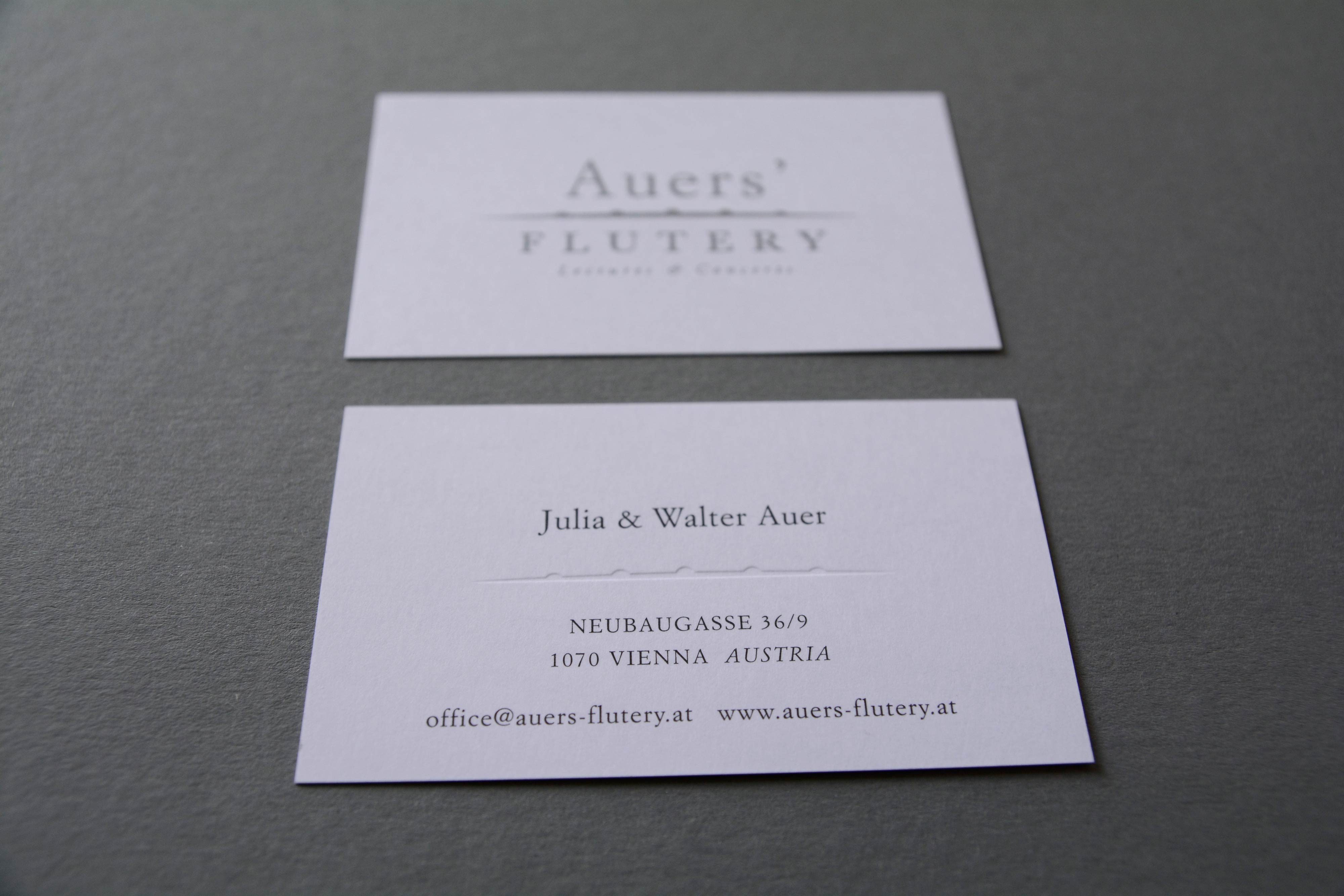 Detail shot of business card. Part of logo is embossed.