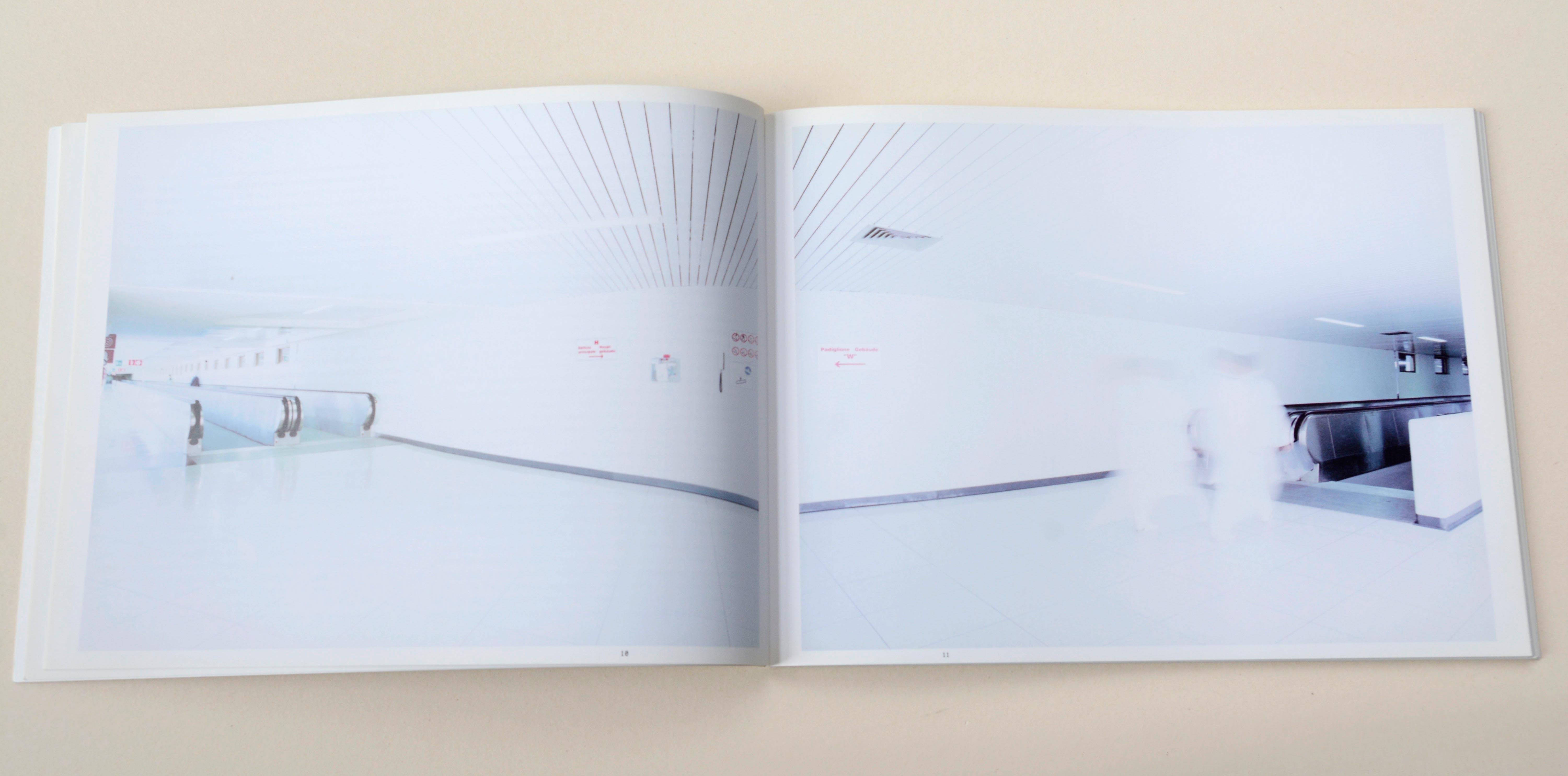 Double page. Large photo with white space around on each page. Left: Connection-corridor at airport. Right: Connection-corridor at airport. 2 shadowy persons walking.