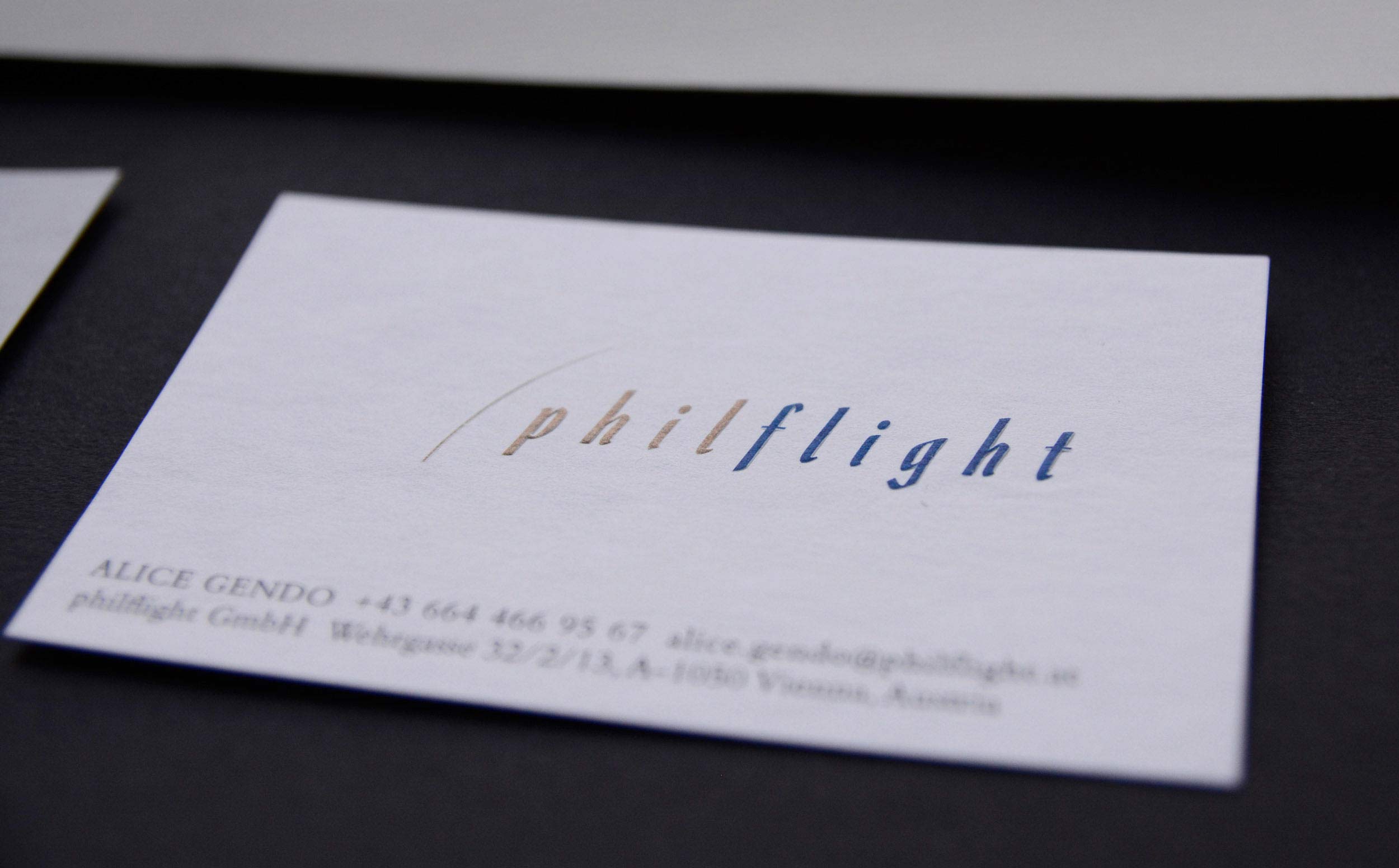 Close-up of business card. Logo is embossed.