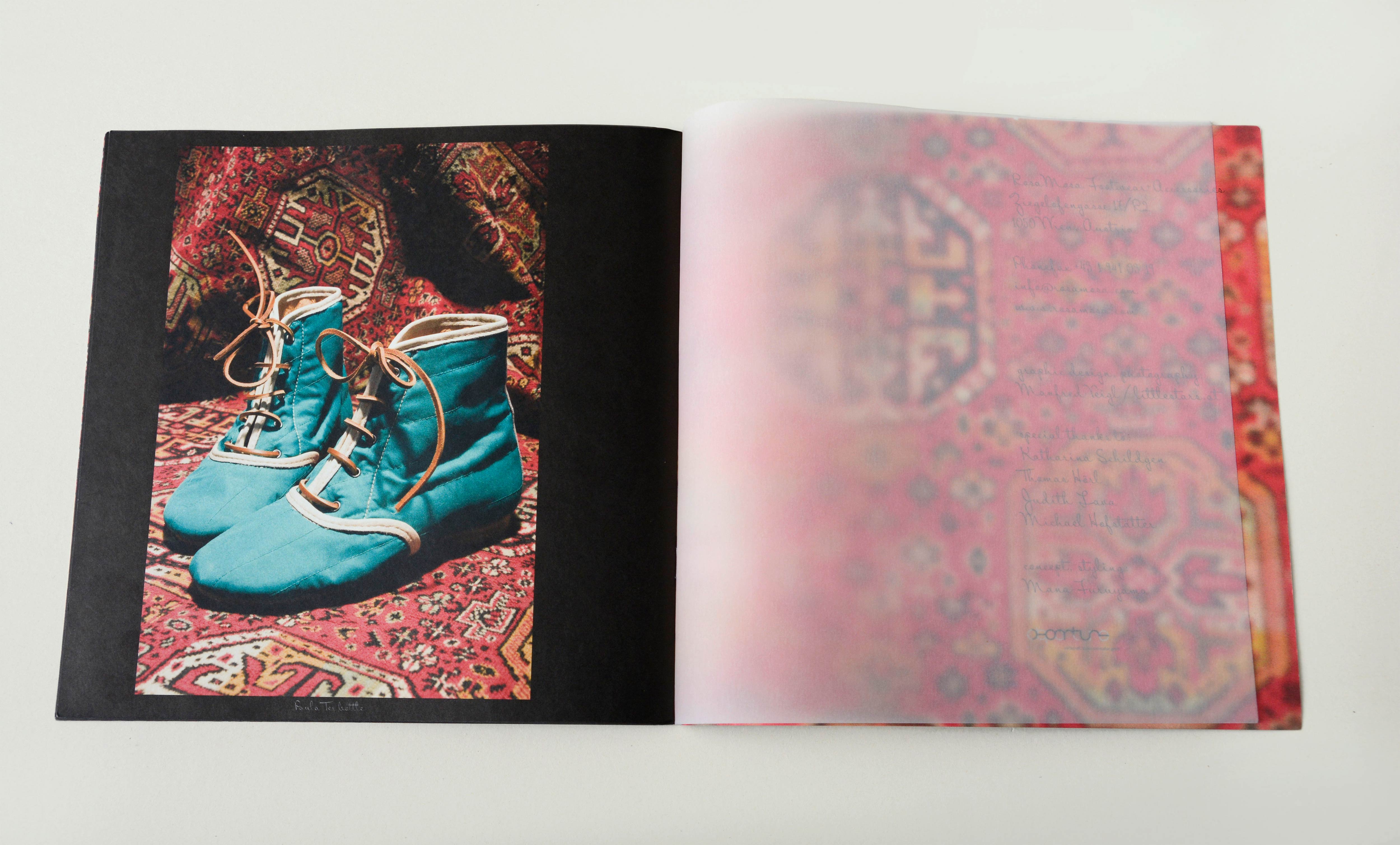 Double page. Transparent page inbetween. Photo of pair of shoes on the left page. Detail of fabric on the right page.