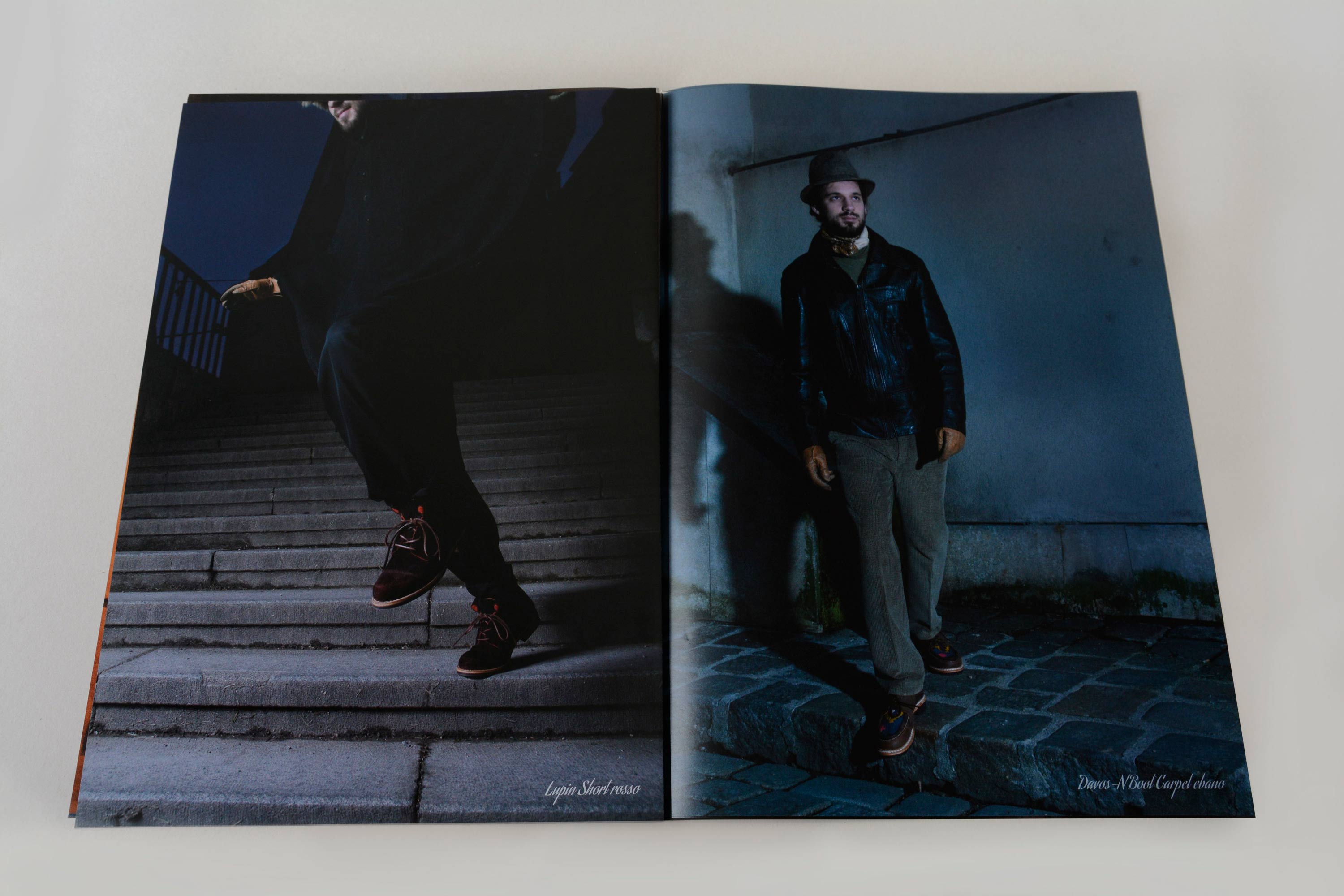 Double page showing full-page night shots. Small script font overlayed at bottom. Left page: Man jumping down stone steps. Right page: Man standing on coblestone pavement in front old wall.