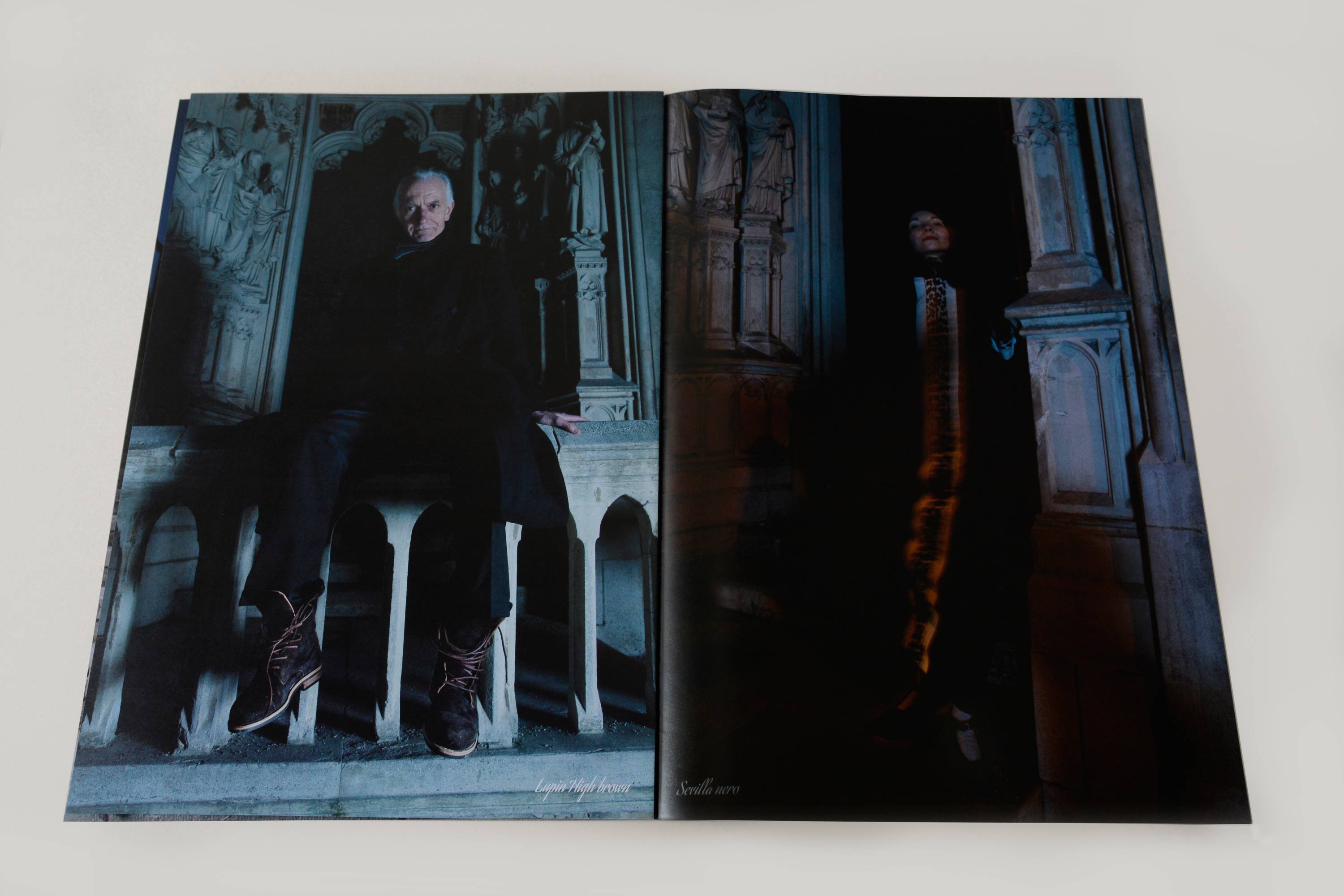 Double page showing full-page night shots. Small script font overlayed at bottom. Left page: Couple in front of heavy medieval metal door. Right page: Man standing on stone steps beside heavy medieval metal door.