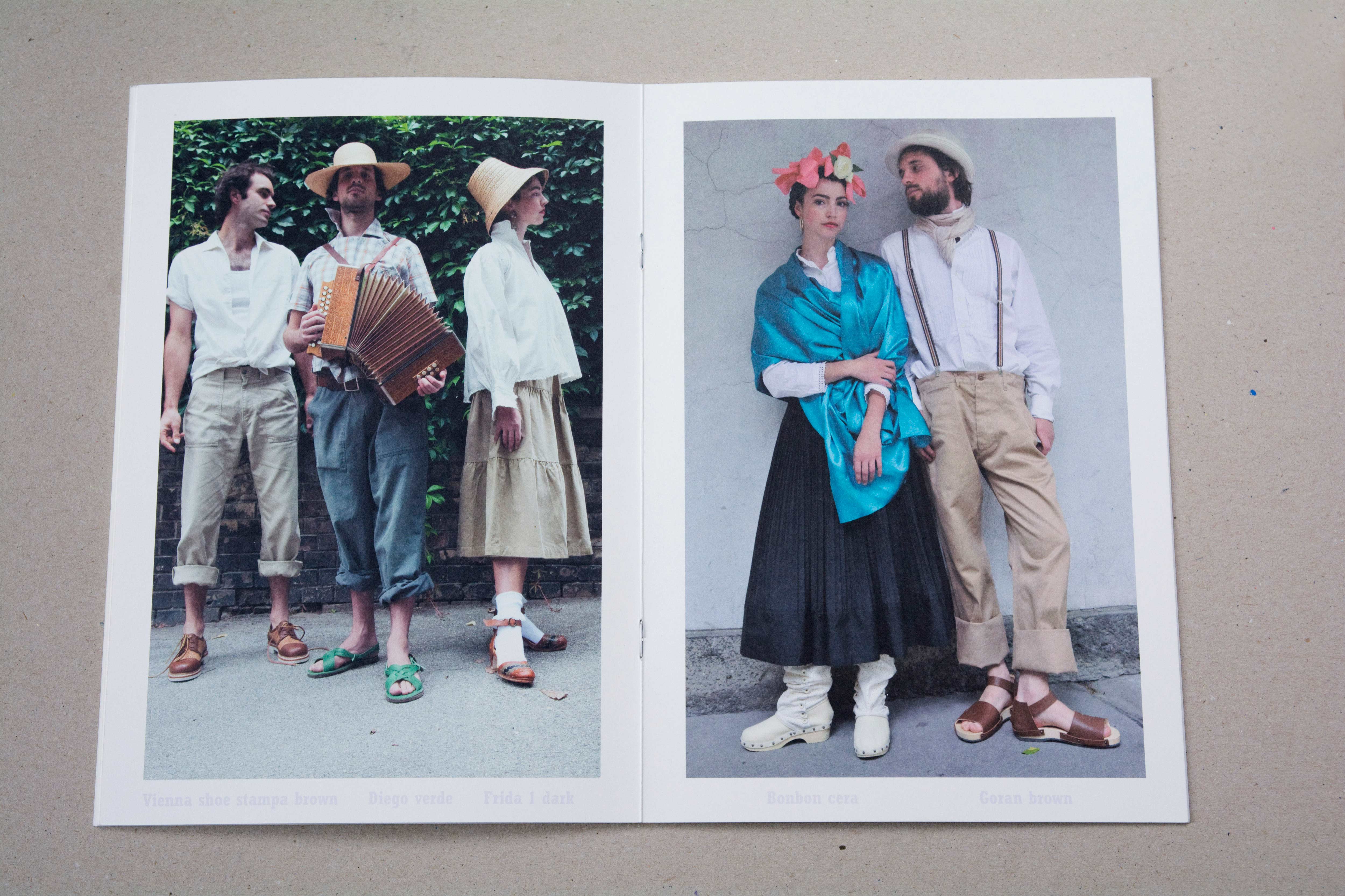 Double page. Large photo on each page. Bold font at bottom underneath photo. Left: 1 woman and 2 men standing on the street in front of an overgrown brick wall. One man holds an accordion. Right: Couple leaning against wall.