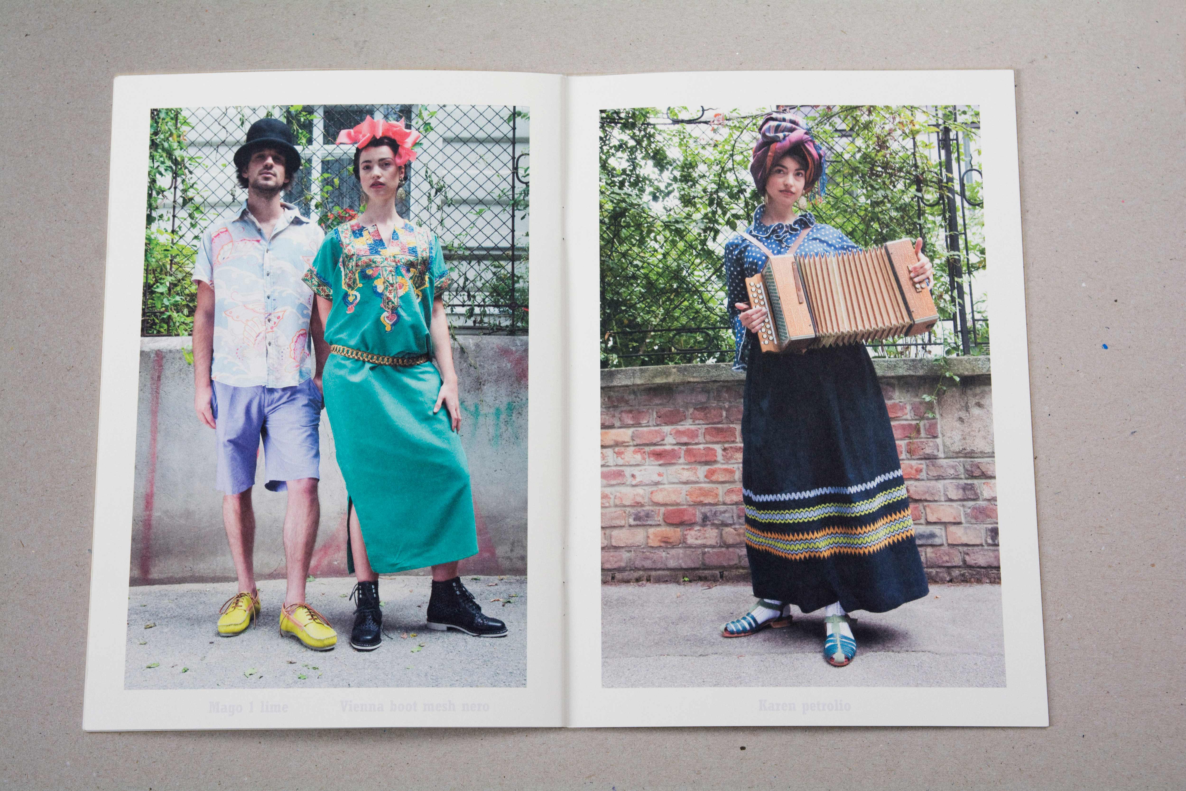 Double page. Large photo on each page. Bold font at bottom underneath photo. Left: Couple standing on the street in front of iron fence on brick wall. Right: Woman standing on the street in front of iron fence on brick wall. She holds an accordion.