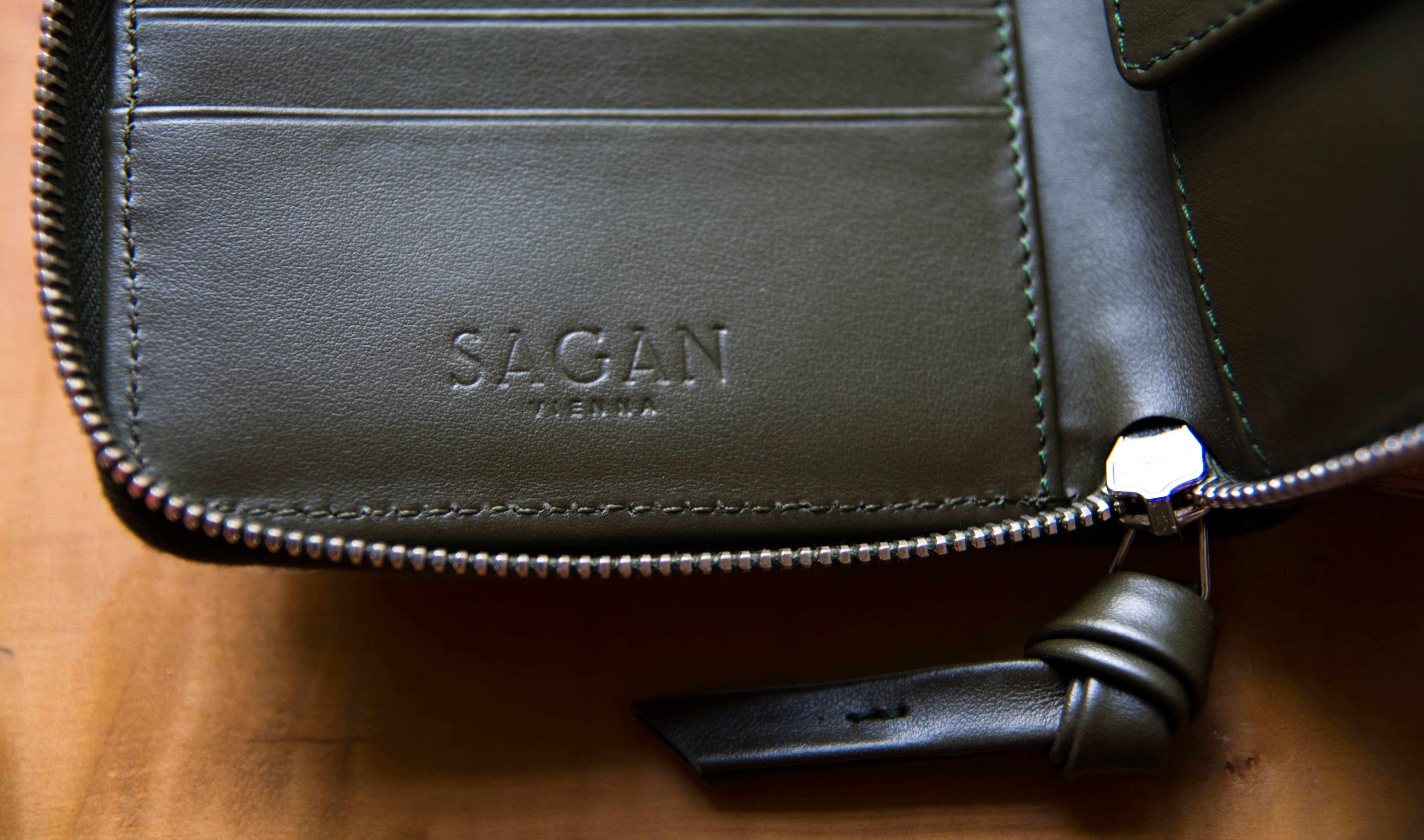Close-up of inside of purse. Punched Logo in leather.
